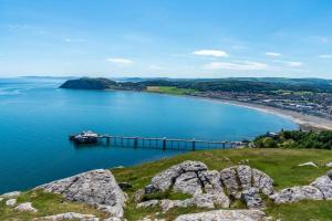 a view of a body of water with a pier at Sea side family rest and holiday in Colwyn Bay