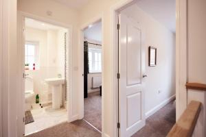 a bathroom with a white door and a sink at Sea side family rest and holiday in Colwyn Bay