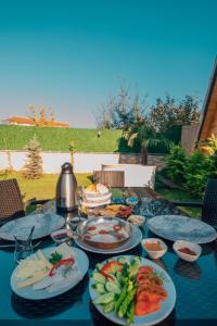 a blue table with plates of food on it at KARMATTE BUNGALOW in Kartepe