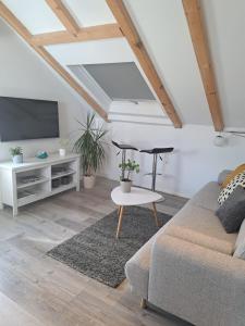 a living room with a couch and a tv at Guest House Kala in Split