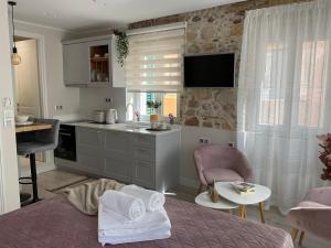 a kitchen with a bed and a table in a room at Biscoutsis old town studio in Corfu