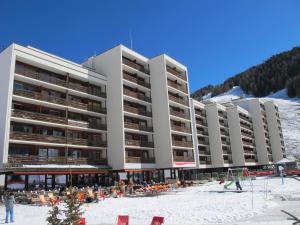 a large building with a beach in front of it at Residenz Rosablanche, TORTIN SIVI158 in Siviez