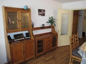 a bedroom with a wooden cabinet and a desk at Residenz Rosablanche, TORTIN SIVI158 in Siviez