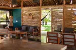 a restaurant with a table and chairs and a couch at Hotel VilaVeraTheresa in Fortim