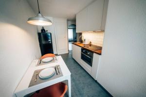 a small kitchen with a white counter and a stove at theNest Glarus Studio-Apartment in Glarus