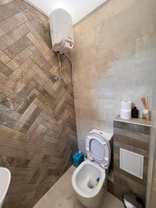 a bathroom with a toilet and a sink at Hilton Burgas Holiday Home in Burgas City