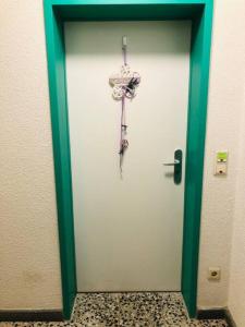 a door with an umbrella hanging on it at Zentrale Studio Wohnung in Emden in Emden