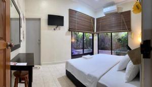 a bedroom with a large white bed and a window at Ardour Lodge "B" Wing in George Town