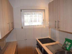 a small kitchen with a sink and a window at Holiday home Karwendel in Füssen