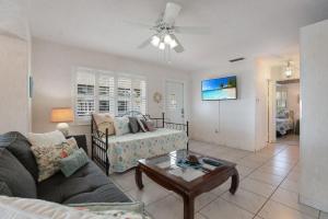 a living room with a couch and a table at Ugly Tuna Down home in Anna Maria