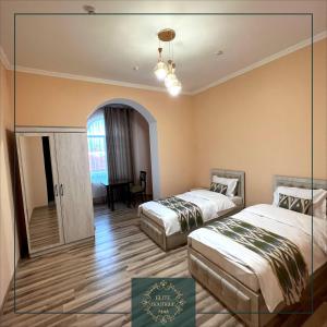a hotel room with two beds and a mirror at Elite Boutique in Samarkand