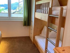 um quarto beliche com 2 beliches e uma janela em Holiday apartment in Pinzgau with a large terrace em Mittersill