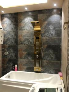 baño con bañera y teléfono en la pared en شقة مفروشة هاى سوبر لوكس بجوار سيتى ستارز, en El Cairo