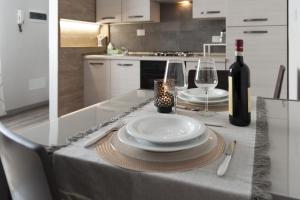 a table with a plate and wine glasses on it at SantaBarbara in Meleto +10 photos