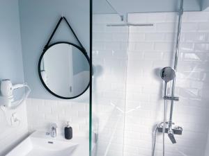 a bathroom with a shower with a sink and a mirror at Central Olhão Home - Private Spacious Sunlit Patio in Olhão +21 photos