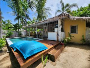 a house with a swimming pool in front of it at Bamboo Lodge in Gili Trawangan