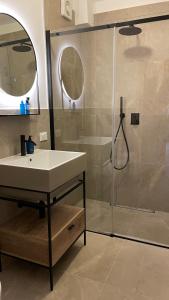 a bathroom with a sink and a shower at iRIVAS Lodge in Pellizzano