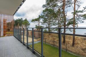 a balcony with a view of the ocean at VacationClub - Let’s Sea Baltic Park B40 in Gąski