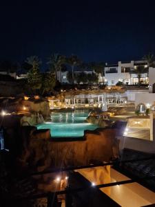 a swimming pool at night with lights at Domina Coral Bey Harem in Sharm El Sheikh
