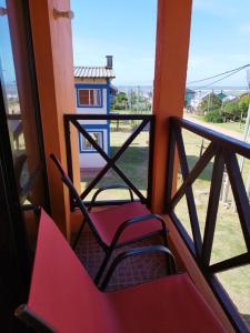a room with two chairs sitting on a balcony at Alas del Mar in Punta Del Diablo