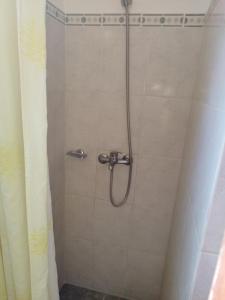 a shower with a shower head in a bathroom at Alas del Mar in Punta Del Diablo