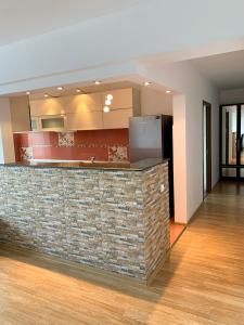 a kitchen with a stone counter top in a room at Sunny Central Apartments Suceava in Suceava