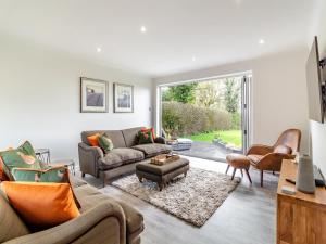 a living room with a couch and a table at Longridge in Peldon