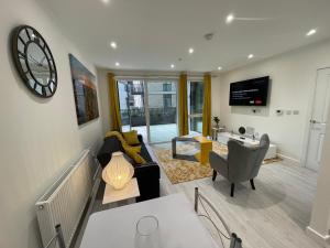 a living room with a couch and a table at BrandNew Luxurious 2Bed Apartmnt in Bexleyheath