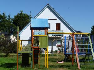 a house with a play equipment in front of it at Apartment Käpt'n Max in Karlshagen