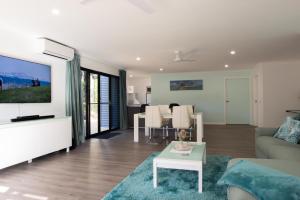 a living room with a couch and a table at 2 Bedroom Studio - Korindi BnB - Batemans Bay Area in Long Beach