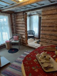 a room with a bed and a table and chairs at Namiņš in Vecumnieki