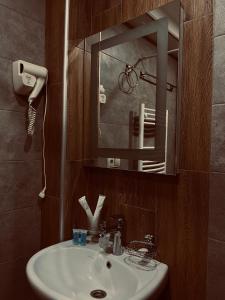 a bathroom with a sink and a mirror at Hotel Gold Kazbegi in Stepantsminda