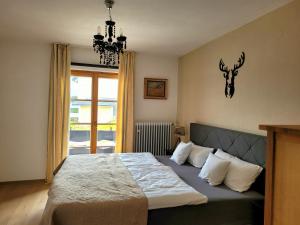 a bedroom with a bed with a deer head on the wall at Villa Hubertus in Feldberg