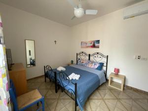 um quarto com uma cama e uma cruz na parede em Casa Vacanze J&F em Pozzallo