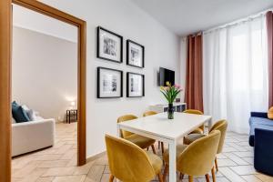 a living room with a table and chairs and a mirror at Pantheon Boutique Apartment "La Dolce Vita" in Rome