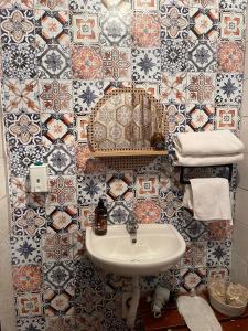 a bathroom with a sink and a tiled wall at Karbeyaz Hotel & Resort in Aksaray