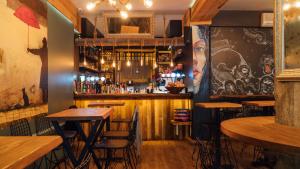 a bar with wooden tables and chairs in a restaurant at Barkod Otel in Istanbul