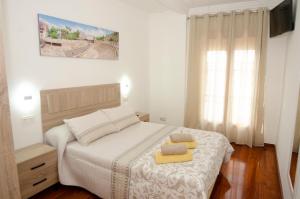 Łóżko lub łóżka w pokoju w obiekcie Casa del Patio Andaluz