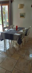 a dining room table with a blue table cloth on it at Gîtes le clos du verger in Maurens