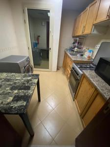 a kitchen with a stove and a counter top at MBZ - Comfortable Room in Unique Flat in Abu Dhabi