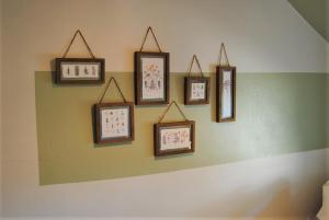 a group of framed pictures on a wall at Snowdon Cottage 2 in Llanrug