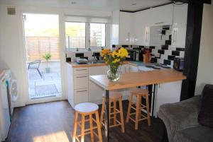 a kitchen with a vase of flowers on a table at Snowdon Cottage 2 in Llanrug