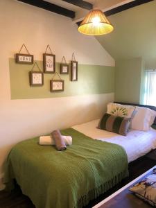 a bedroom with two beds with towels on them at Snowdon Cottage 2 in Llanrug