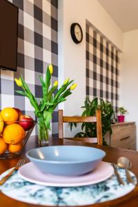 a wooden table with a bowl of fruit on top of it at ENERGYLANDIA Zator Apartament Asia in Zator