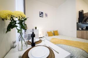 ein Wohnzimmer mit einem Tisch mit einer Vase gelber Blumen in der Unterkunft New apartments near Dancing house in Prag