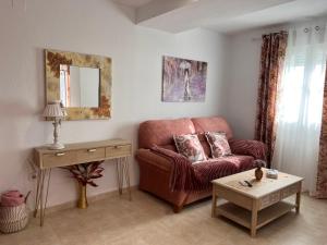 a living room with a couch and a table at Estudios Costavigía Mazagón by Ramona in Mazagón