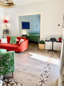 a living room with a red couch and a table at La Rovettina Pet friendly house in Salò