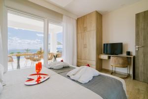 a bedroom with a bed with a view of the ocean at The Three Graces in Antimácheia