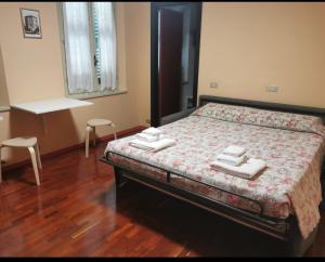 a bedroom with a bed with towels on it at B&B La Chicca in Ravenna