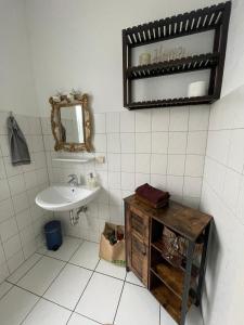 a bathroom with a sink and a mirror at Apartment Gartenstrasse 3 in Ostseebad Sellin +39 photos
